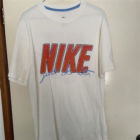 white and orange Nike shirt